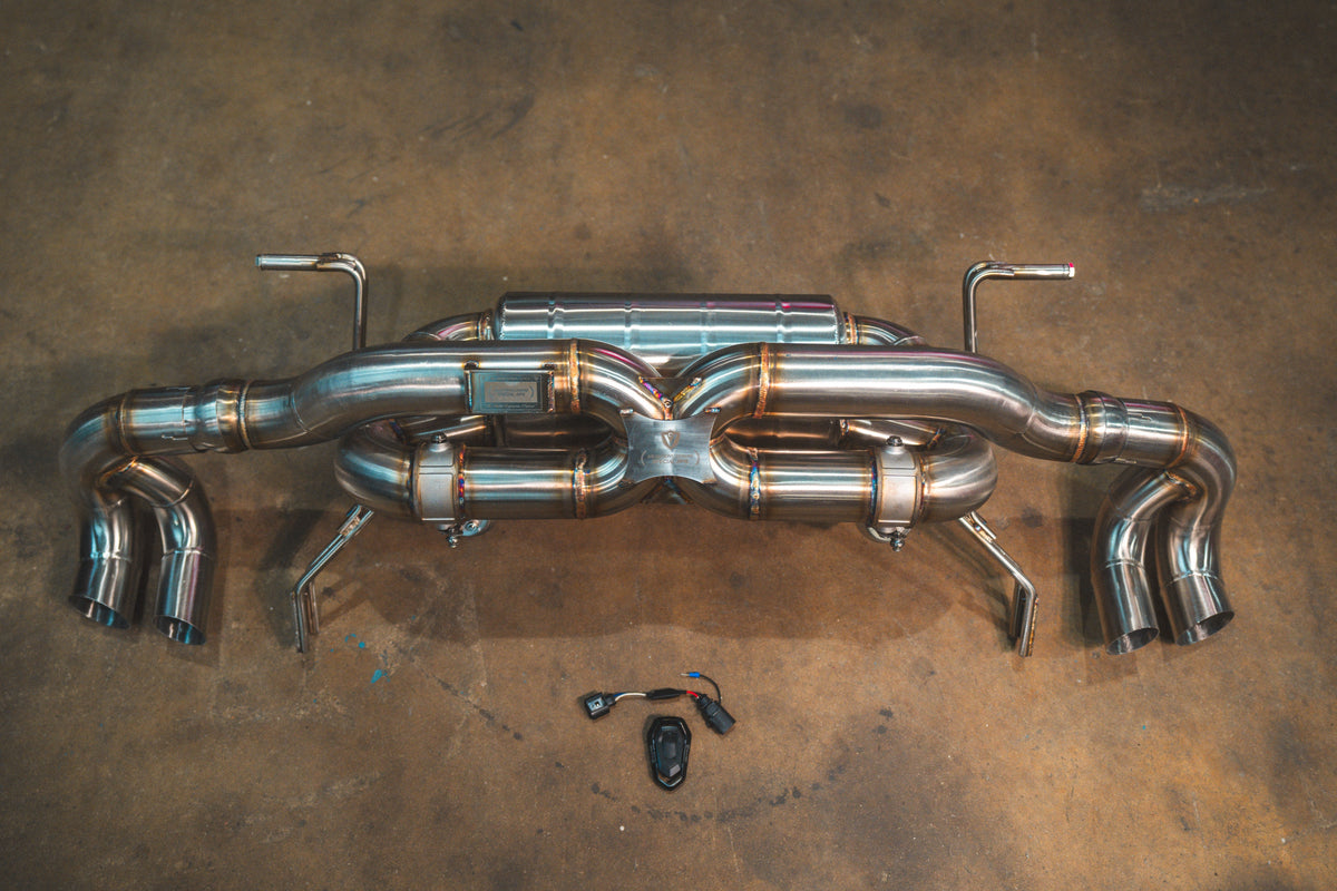 Valved sport exhaust system for Lamborghini Gallardo LP, polished stainless steel with twin mufflers, X-pipe and curved outlets.