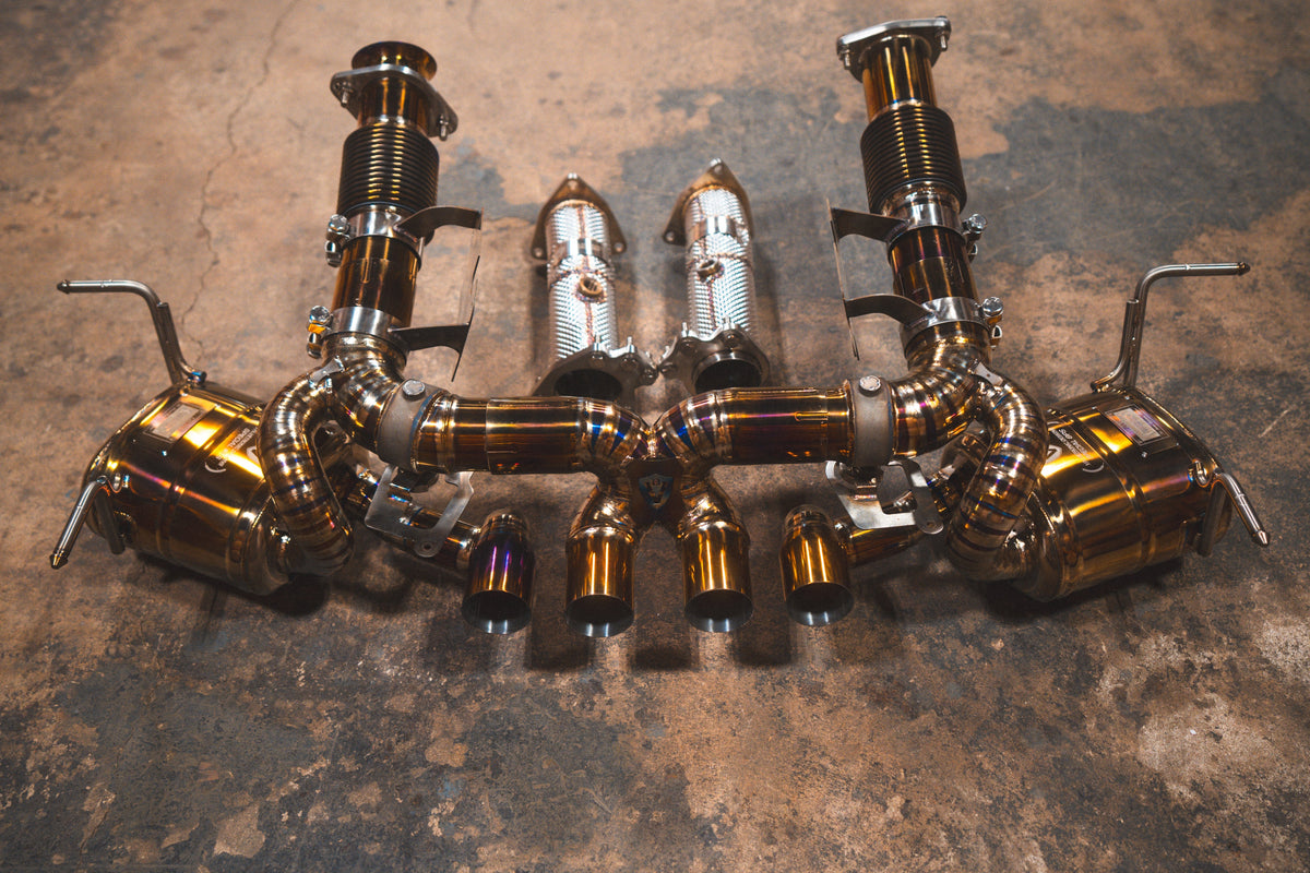 Valved sport exhaust system for Chevrolet Corvette C8 Z06, polished titanium tubing with bronze heat tint and paired mufflers.