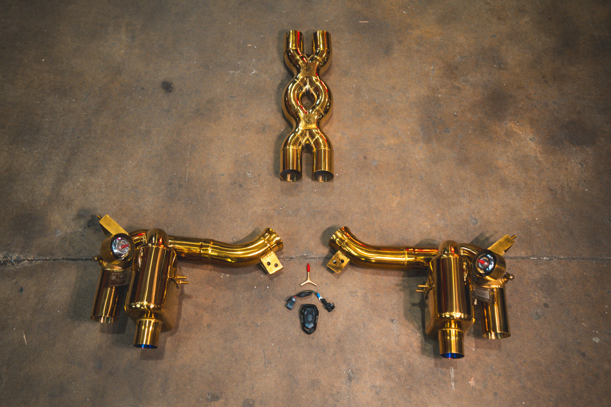 Ferrari GTC4 Lusso Valved Exhaust system in polished gold-tone metal, featuring twin mufflers, curved pipes and an X-pipe.