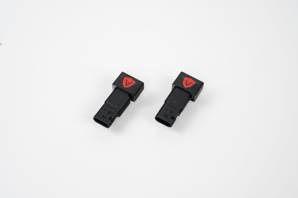 Valvetronic Designs Electronic Valve Simulators, a pair of black plastic plug-in connectors with red logos and molded housings.