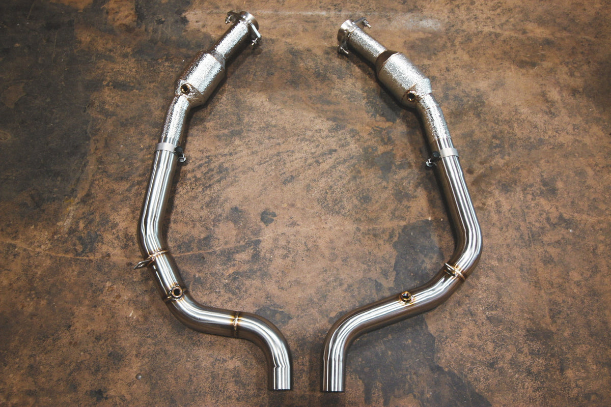 Range Rover Free Flow Front Pipes in polished silver metal, paired curved exhaust pipes with welded joints and flanges.